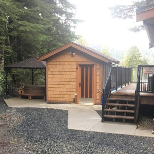 The covered Hot Tub, Bunkhouse, and stairs to the Deck and Cottage entrance