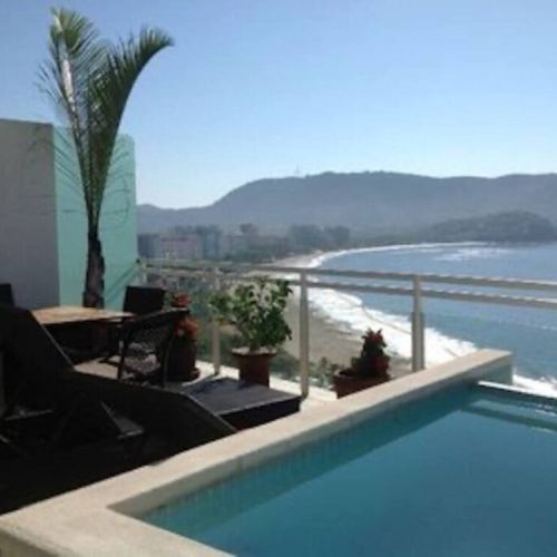 Patio, infinity pool and view of the beach and mountains