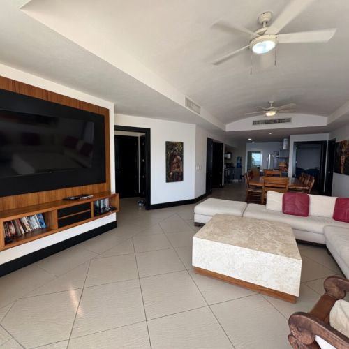 Living room TV area, bedroom entrance and kitchen